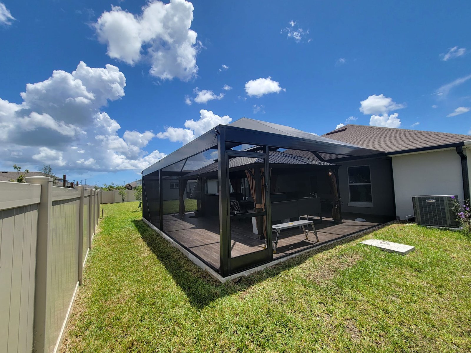 Screen enclosure in a house patio